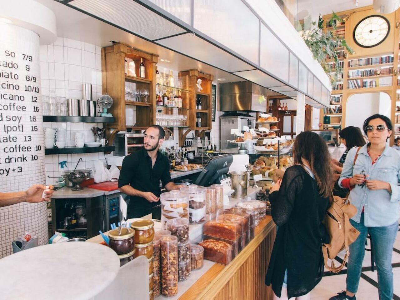 A busy scene at a hip, modern coffee shop.