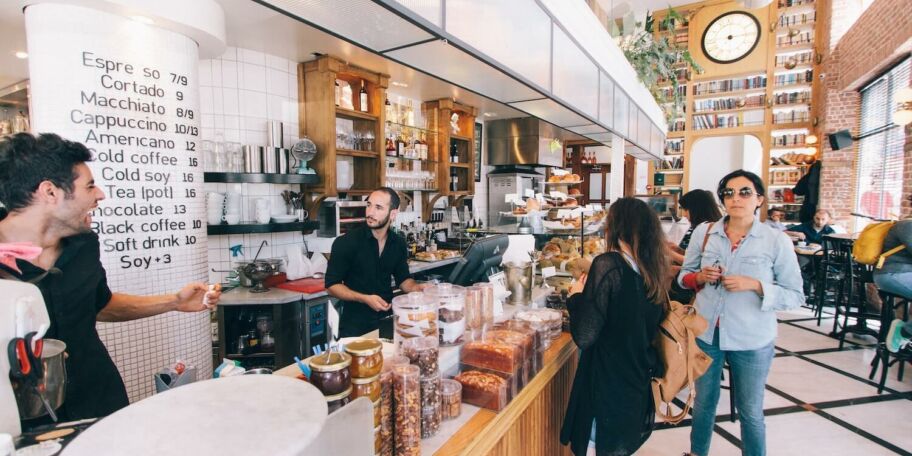 A busy scene at a hip, modern coffee shop.